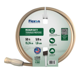 Close-up of a circular tape measure with a beige outer housing and a green label on the inner face showing measurements and icons.